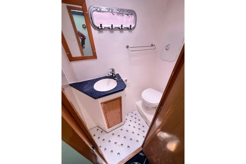Slide: The Image of Compact bathroom in 2008 Admiral 40 Cruiser with sink, toilet, and mirror. - 85