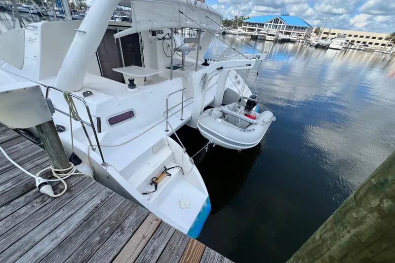 Slide: The Image of 2008 Admiral 40 Cruiser docked with inflatable dinghy, marina background. - 9