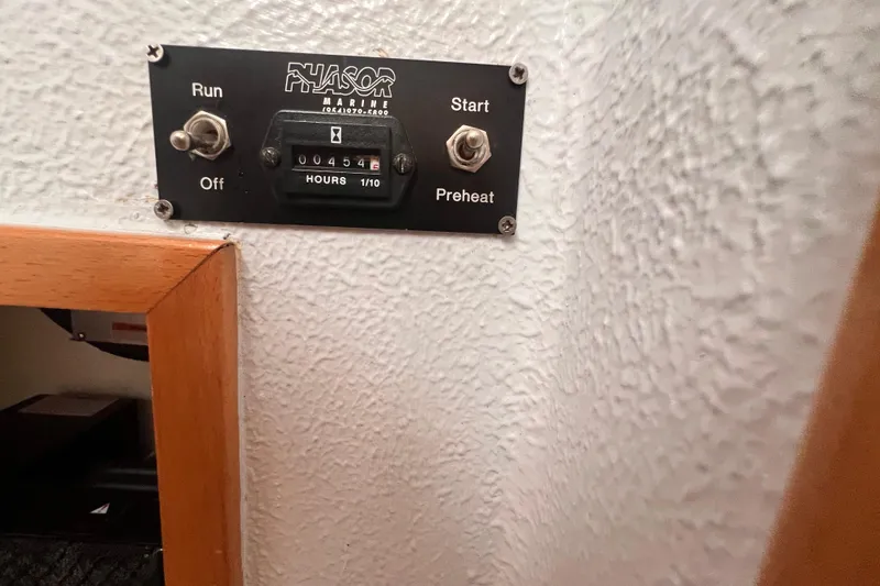 Slide: The Image of Control panel of a 2008 Admiral 40 cruiser with hour meter reading 454. - 78