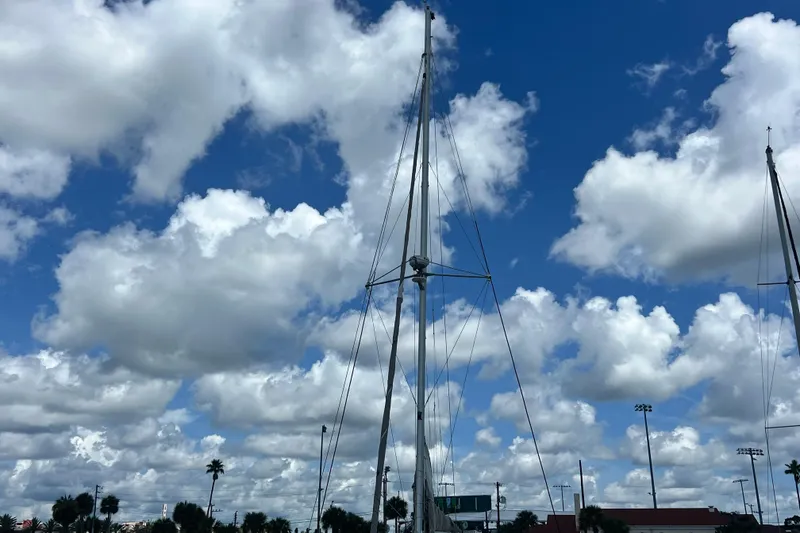 Slide: The Image of Sailboat mast of 2008 Admiral 40 cruiser against a cloudy blue sky. - 11
