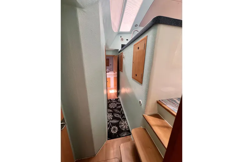 Slide: The Image of Interior hallway of 2008 Admiral 40 Cruiser with wooden steps and decorative rug. - 79