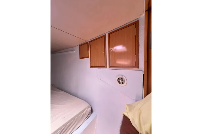 Slide: The Image of Interior cabin of 2008 Admiral 40 Cruiser with wooden cabinets and bed. - 89