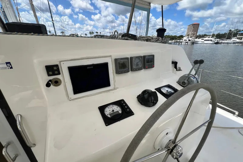 Slide: The Image of Helm of 2008 Admiral 40 Cruiser with navigation instruments and steering wheel, docked at marina. - 39