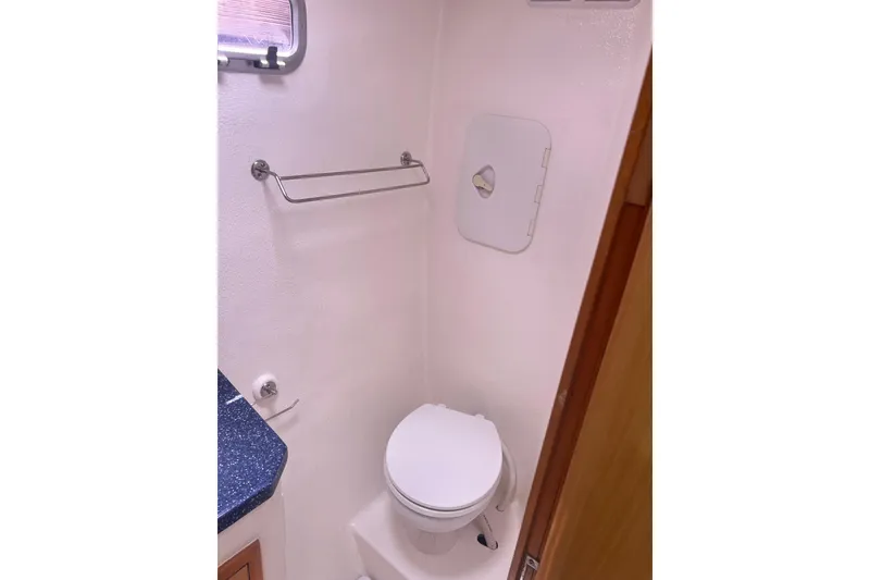Slide: The Image of Compact bathroom in 2008 Admiral 40 Cruiser yacht, featuring toilet and towel rack. - 83
