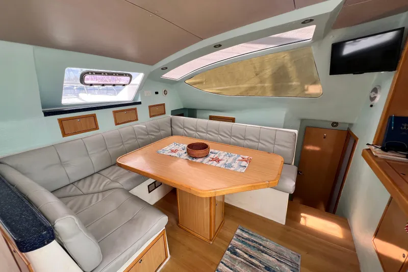 Slide: The Image of Interior of 2008 Admiral 40 Cruiser with cozy seating and dining area. - 48