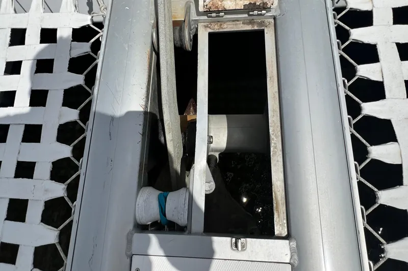 Slide: The Image of Close-up of a 2008 Admiral 40 Cruiser's deck with netting and mechanical components. - 24