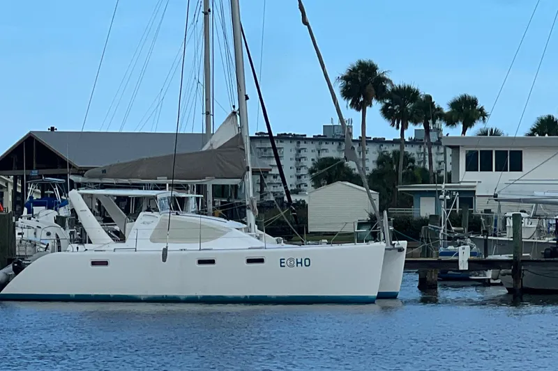 Slide: The Image of 2008 Admiral 40 Cruiser yacht docked at marina with palm trees in background. - 4