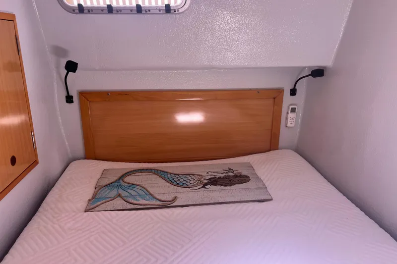 Slide: The Image of Cozy cabin bed in 2008 Admiral 40 cruiser with mermaid-themed decor. - 73