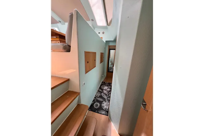 Slide: The Image of Interior of 2008 Admiral 40 Cruiser, featuring wooden stairs and modern design elements. - 62
