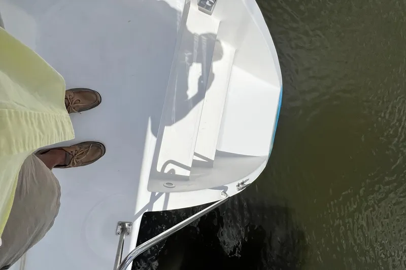 Slide: The Image of Man standing on 2008 Admiral 40 cruiser deck, overlooking water. - 35