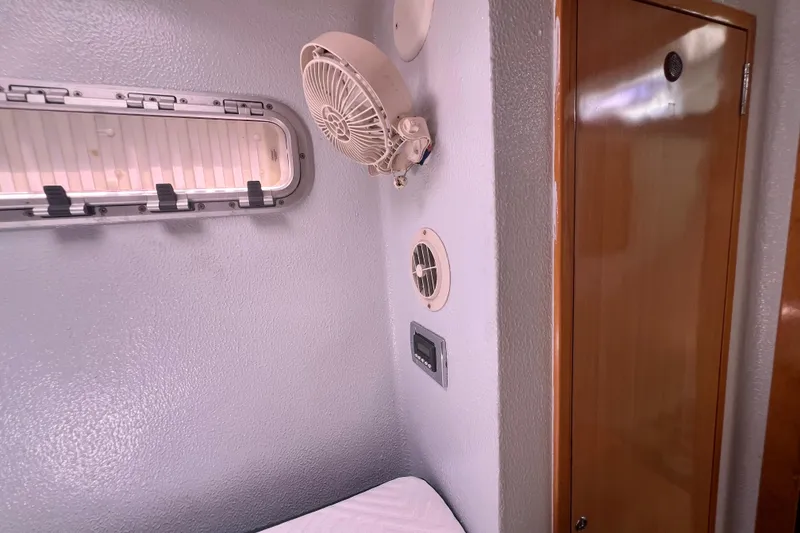 Slide: The Image of Interior of 2008 Admiral 40 Cruiser with fan, vent, and wooden door. - 75