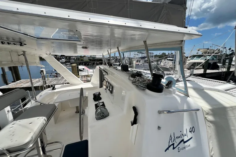 Slide: The Image of Cockpit view of 2008 Admiral 40 Cruiser at marina, showcasing helm and seating area. - 31
