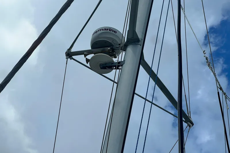 Slide: The Image of Radar equipment on a 2008 Admiral 40 cruiser sailboat mast against cloudy sky. - 13