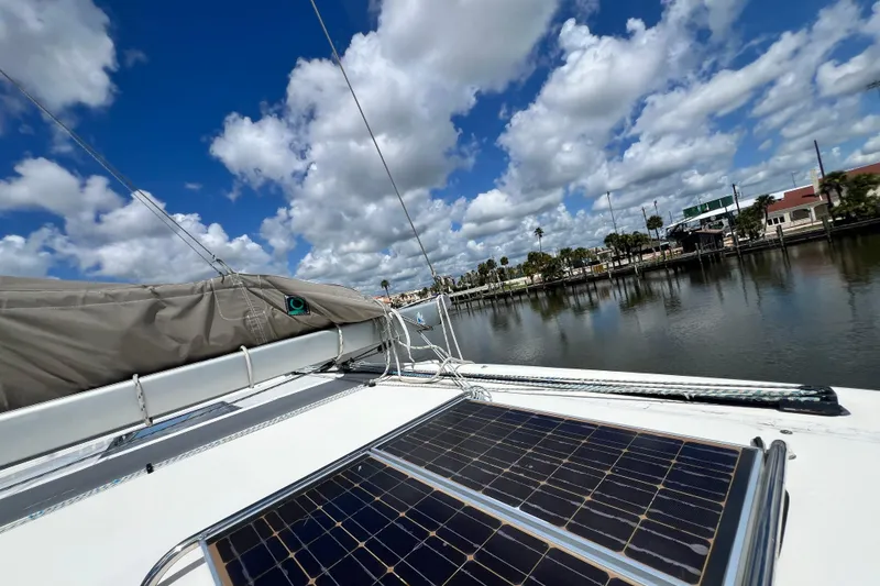 Slide: The Image of Sailboat deck with solar panels, Admiral 40 cruiser, 2008, under a partly cloudy sky. - 17