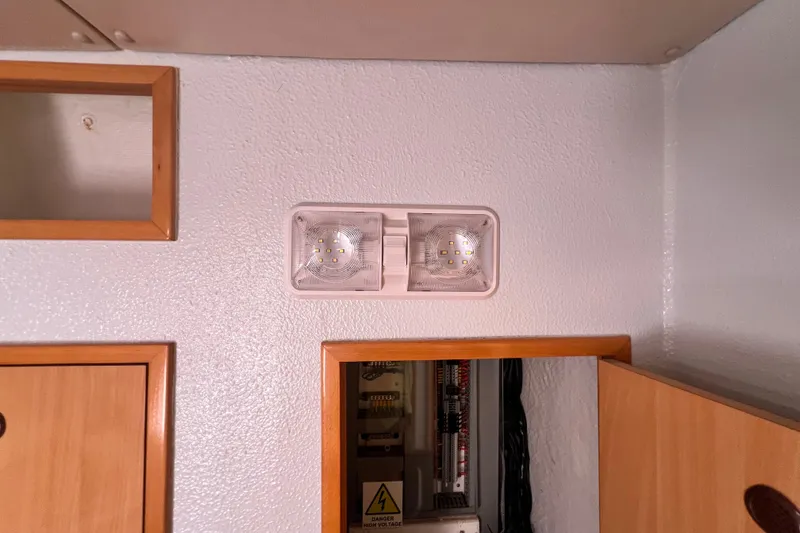 Slide: The Image of Interior of 2008 Admiral 40 cruiser showing wall light fixture and wooden cabinetry. - 61