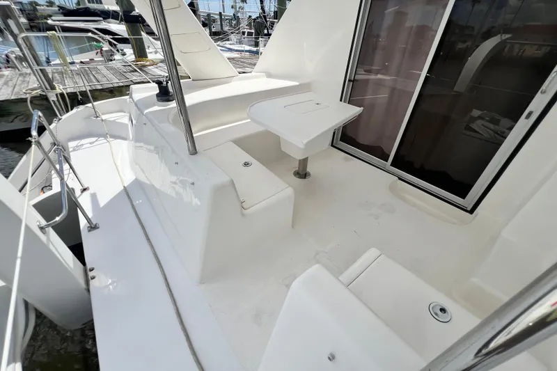 Slide: The Image of 2008 Admiral 40 Cruiser yacht deck with seating and table, docked at marina. - 36