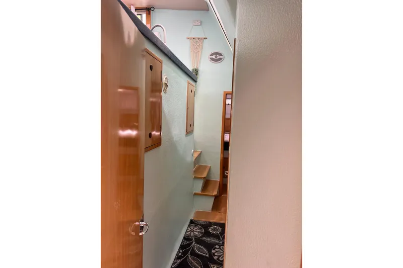 Slide: The Image of Narrow interior passageway with wooden steps in a 2008 Admiral 40 cruiser yacht. - 90