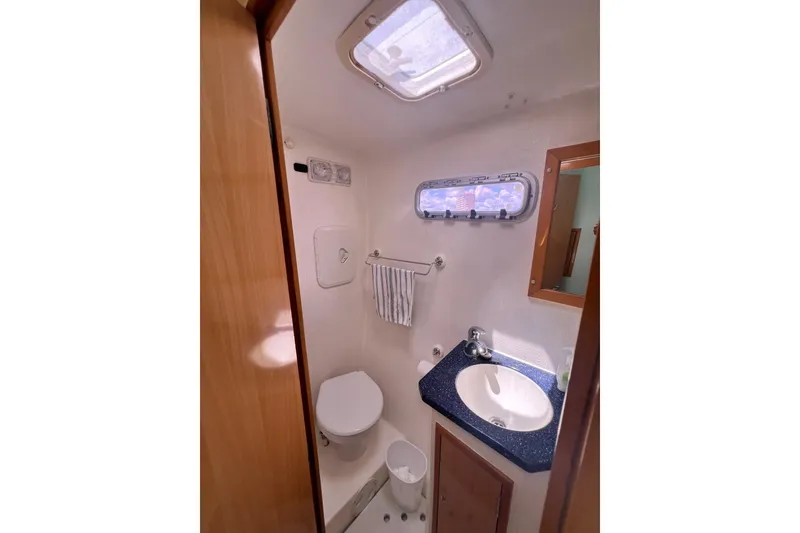 Slide: The Image of Compact bathroom in 2008 Admiral 40 Cruiser yacht with sink, toilet, and window. - 63