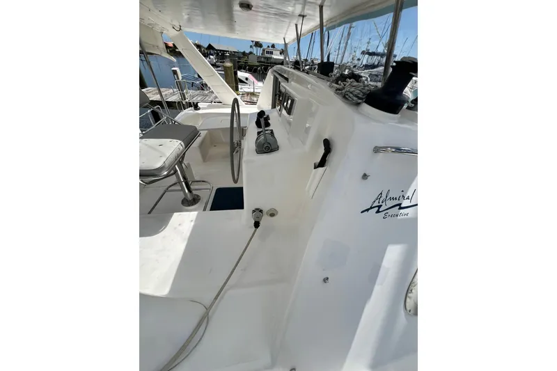 Slide: The Image of 2008 Admiral 40 Cruiser yacht cockpit with steering wheel and seating, docked at marina. - 40