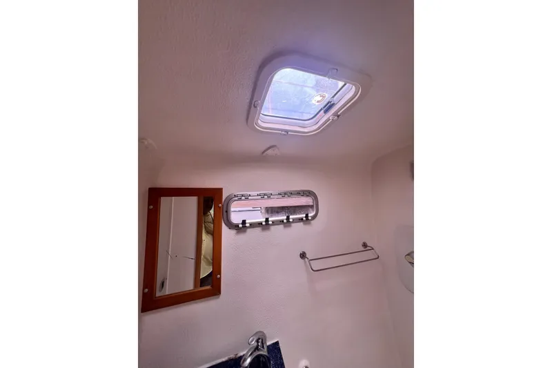 Slide: The Image of Interior of 2008 Admiral 40 cruiser bathroom with skylight, mirror, and towel rack. - 86