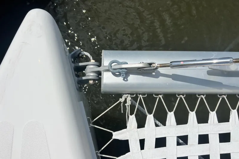 Slide: The Image of Close-up of 2008 Admiral 40 cruiser catamaran rigging and netting over water. - 26