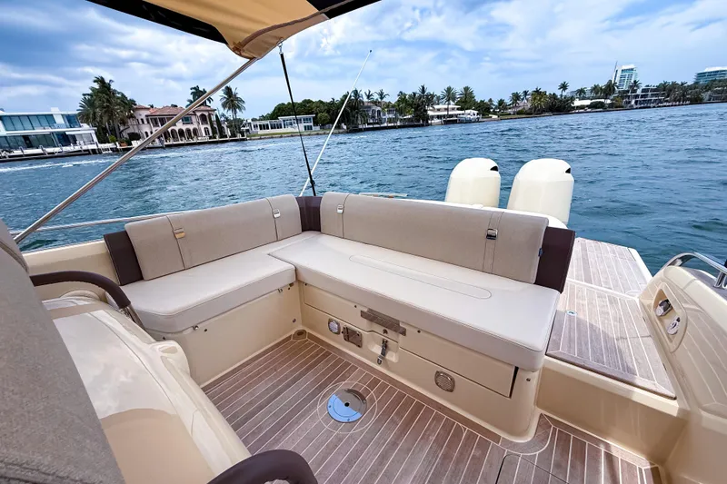 Slide: The Image of 2023 Invictus GT280S luxury boat interior with elegant seating and scenic waterfront view. - 11