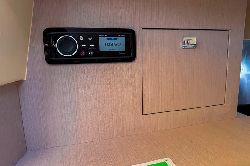 Slide: The Image of 2023 Invictus GT280S interior with Fusion stereo system and wooden cabinet. - 28