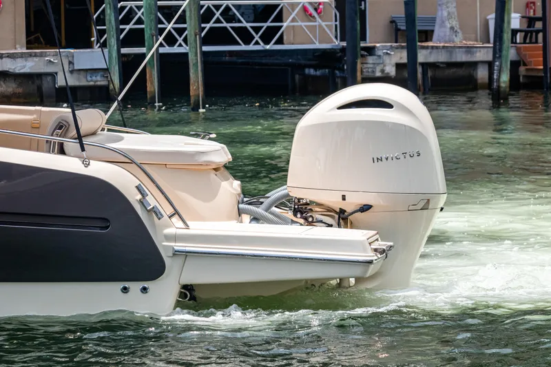 Slide: The Image of 2023 Invictus GT280S boat with outboard motor in marina setting. - 8