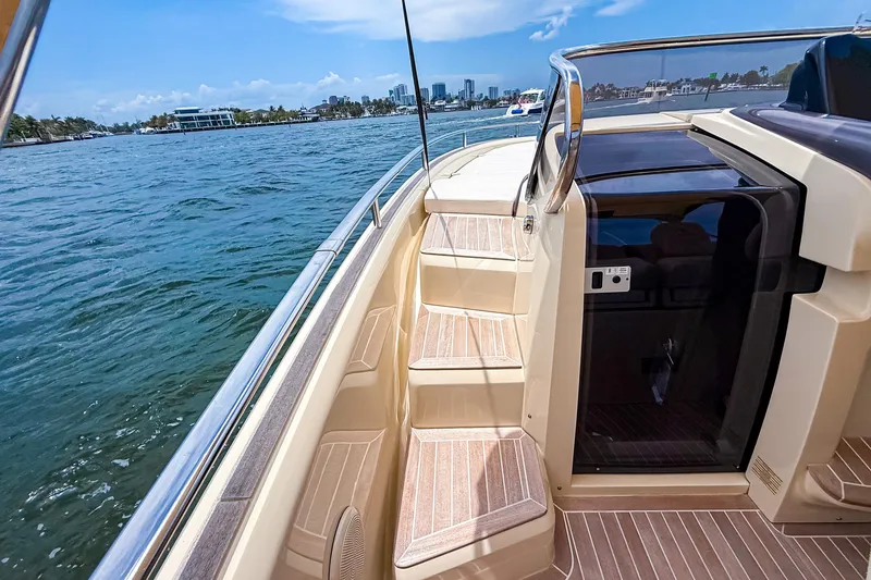 Slide: The Image of 2023 Invictus GT280S yacht deck with steps, overlooking scenic waterfront and skyline. - 29