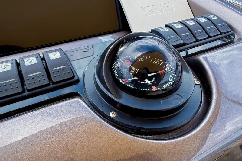 Slide: The Image of Dashboard of 2023 Invictus GT280S featuring compass and control switches. - 23