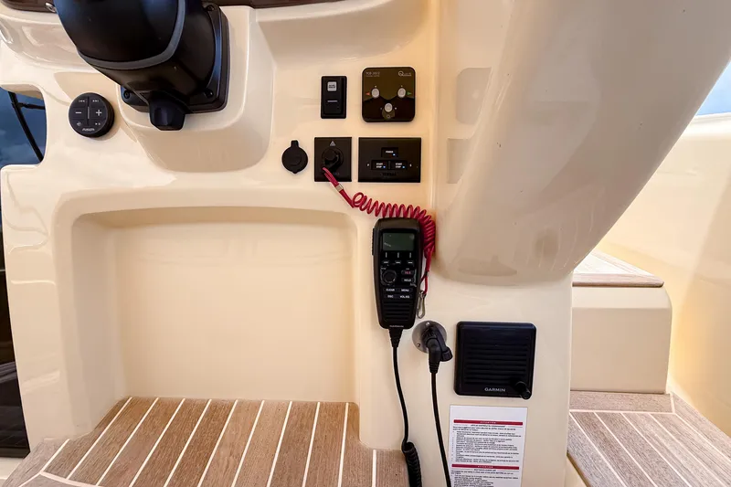 Slide: The Image of Control panel of 2023 Invictus GT280S boat with communication equipment and switches. - 22