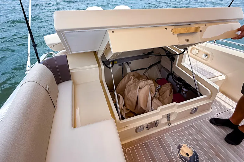 Slide: The Image of Open storage compartment on 2023 Invictus GT280S boat, revealing interior space and equipment. - 12