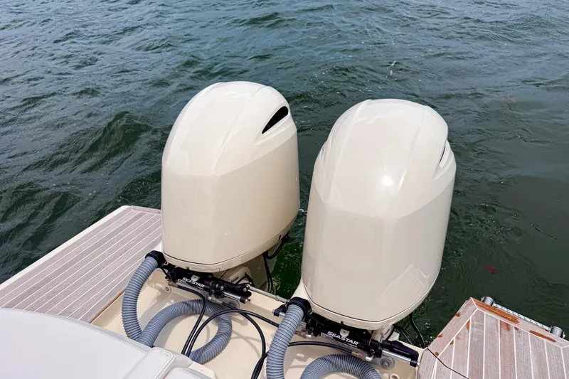 Slide: The Image of Twin outboard motors on 2023 Invictus GT280S boat, docked on water. - 9