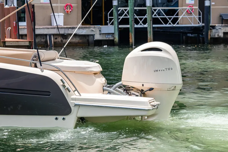 Slide: The Image of 2023 Invictus GT280S boat with outboard motor docked in marina. - 33