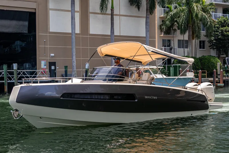 Slide: The Image of 2023 Invictus GT280S luxury boat docked near palm trees and buildings. - 32