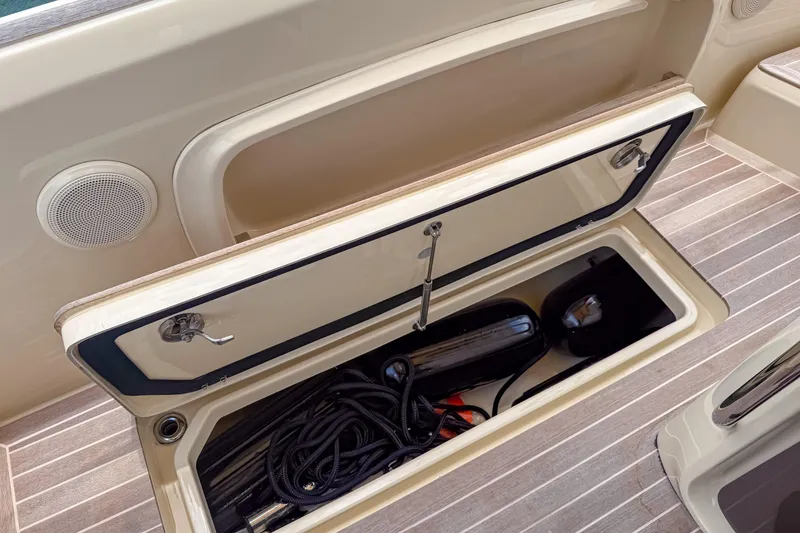 Slide: The Image of Open storage compartment on 2023 Invictus GT280S boat, containing ropes and equipment. - 17
