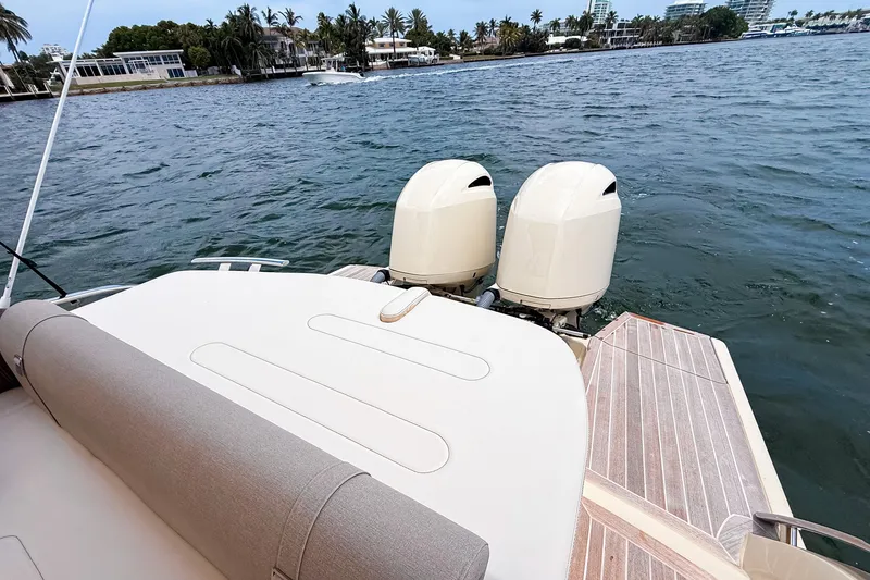 Slide: The Image of 2023 Invictus GT280S boat with dual outboard engines on a calm waterway. - 10