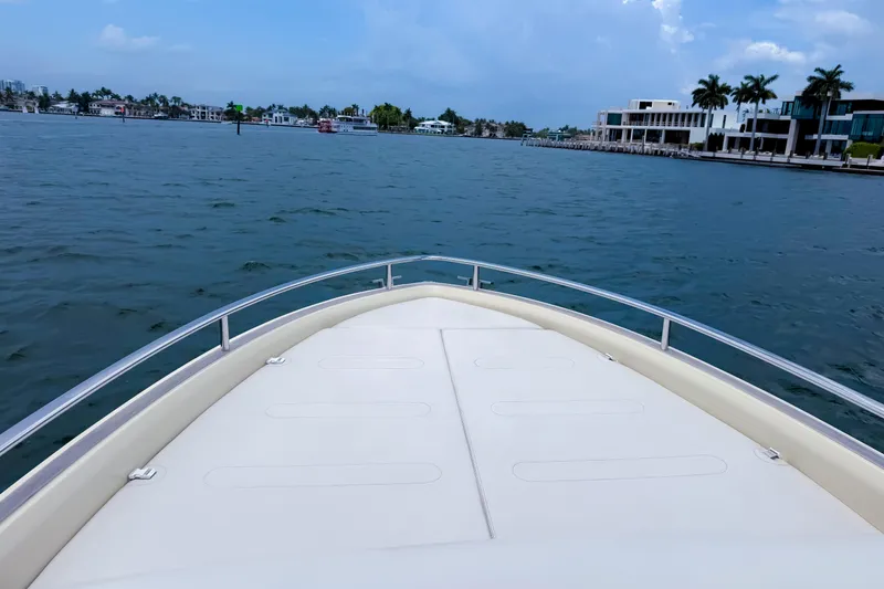 Slide: The Image of Bow view of 2023 Invictus GT280S yacht cruising near waterfront homes. - 30