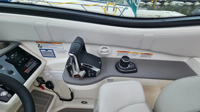 Slide: The Image of The image shows the cockpit of a Sea Ray Sundancer 320 Outboard with modern controls. - 15