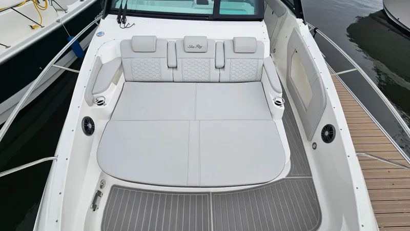Slide: The Image of The image shows the cockpit of a 2025 Sea Ray Sundancer 320 Outboard with gray upholstery. - 28