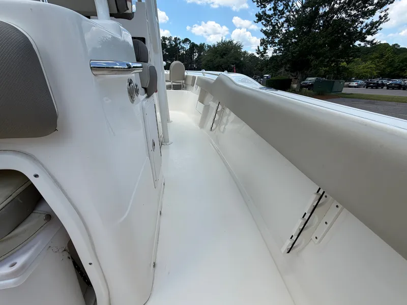 Slide: The Image of The image shows the deck of a 2023 Key West 239 FS boat with white and gray upholstery. - 8
