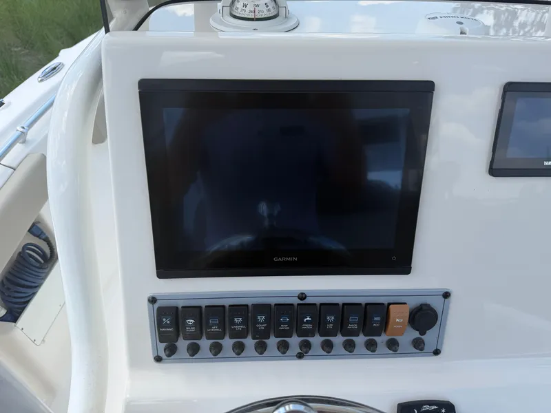 Slide: The Image of The image shows the dashboard of a Key West 239 FS with a Garmin screen and switches. - 11