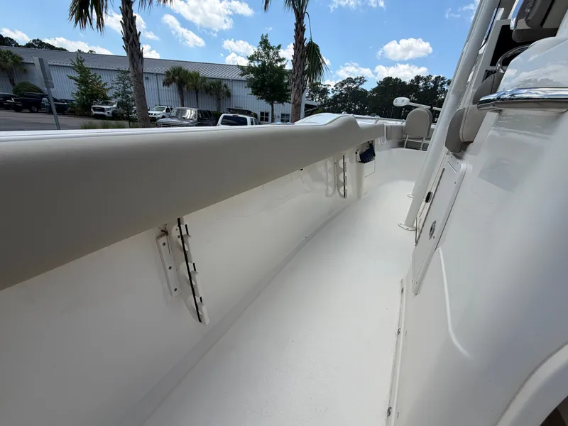 Slide: The Image of The image shows the deck of a 2023 Key West 239 FS boat with clean lines and palm trees in the background. - 7