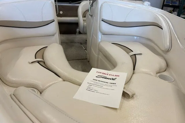 Slide: The Image of 2006 Seaswirl 190 Bowrider I/O boat interior with sale sign, beige seating. - 7