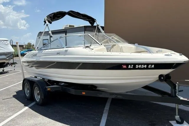 Slide: The Image of 2006 Seaswirl 190 Bowrider I/O on trailer, parked outdoors under sunny skies. - 2