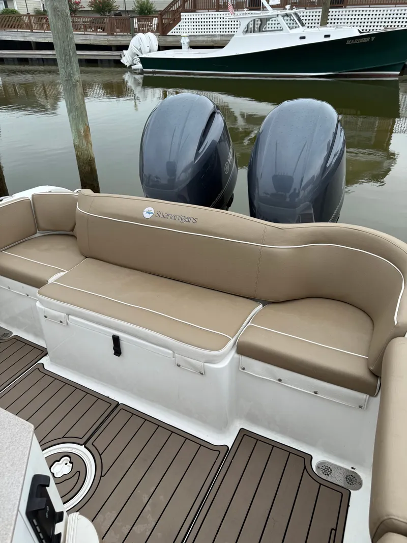 Slide: The Image of The image shows the stern of a Sea Hunt 265 Ultra boat with two outboard engines. - 12
