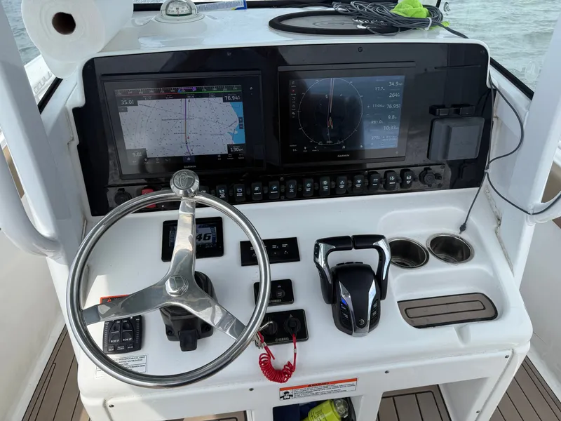 Slide: The Image of The image shows the helm of a 2021 Sea Hunt 265 Ultra boat with modern instruments. - 3