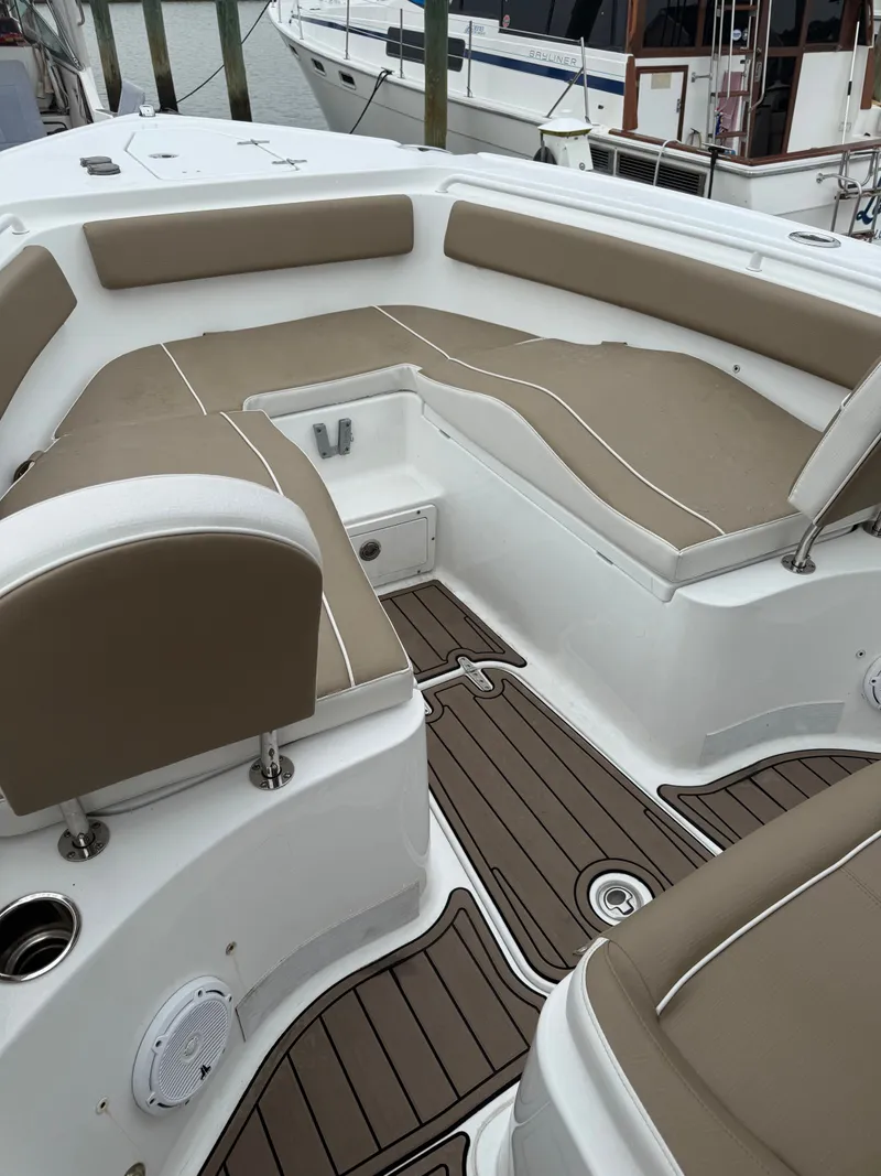 Slide: The Image of The image shows the cockpit of a 2021 Sea Hunt 265 Ultra with brown upholstery. - 9