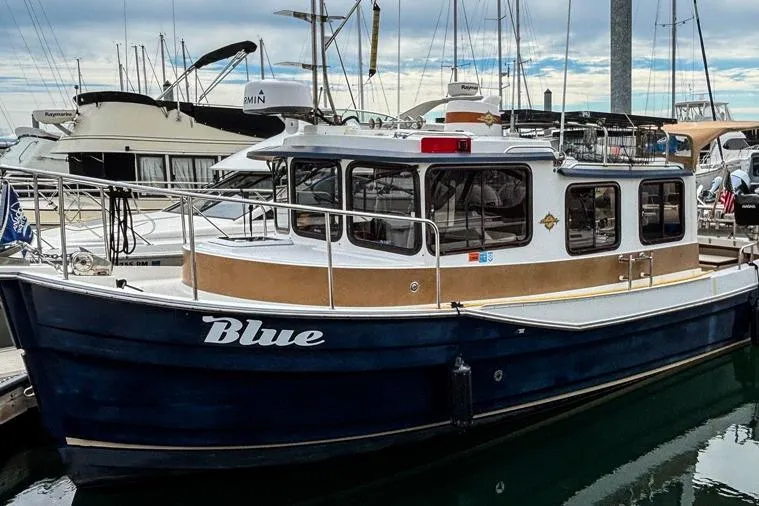 The Image of 2016 Ranger Tugs R-27 boat named "Blue" docked at a marina. - 0