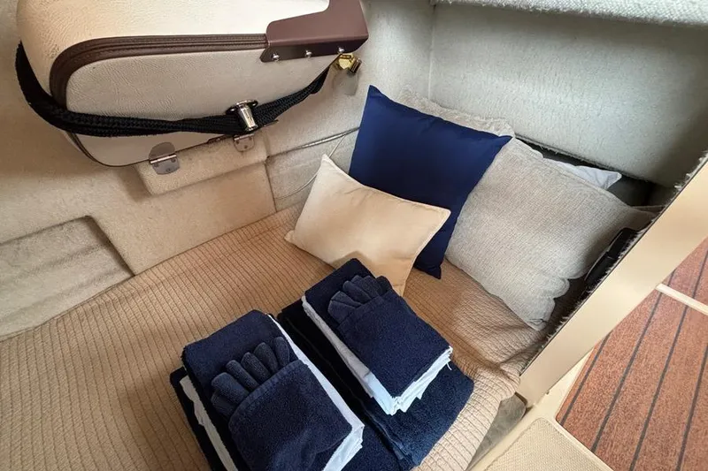 Slide: The Image of Cozy cabin interior of 2016 Ranger Tugs R-27 with neatly arranged pillows and towels. - 2